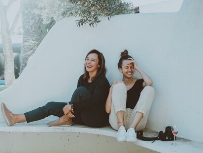 Two women laughing together, realising some stress out. You can discuss your problems with your friends, and close relations