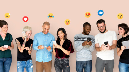 Individuals happily engage with digital devices, displaying smileys overhead, highlighting the intersection of technology, communication, and human connection amidst concerns of smartphone addiction and social media engagement