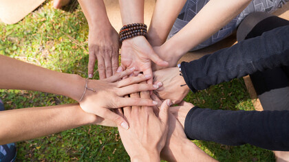 Hands gently resting on lush green grass