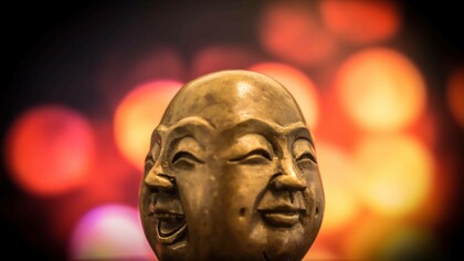 The two faces of Buddha, laughter and happiness