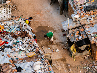 An overhead view of an urban slum community, where residents navigate daily life amid poverty, overcrowding, and public health concerns