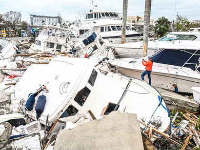 A boat owner taking photos of Hurricane Ian's damage to thousands of boats that were kept within the region's extensive canal system in Fort Meyers, Florida