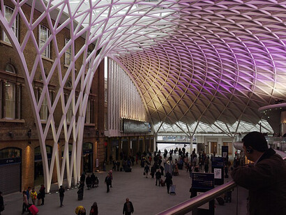 A panoramic view from the balcony of the western concourse at King’s Cross Station in London, reflecting the blend of historic infrastructure and contemporary urban desig