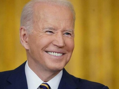 American President Joe Biden smiling at reporters