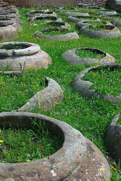 Dolii o orci, contenitori interrati per la conservazione del vino e dell'olio, Ostia Antica. Per i Romani, il vino aveva anche un valore medico: si credeva che avesse proprietà curative e veniva spesso mescolato con erbe per curare varie malattie