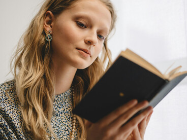 Woman reading a book indoors