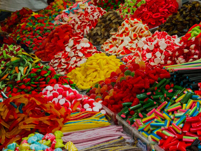 A variety of colorful sweets are neatly displayed, creating a vibrant and tempting scene