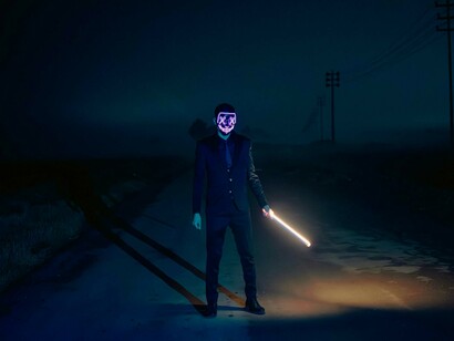 A masked individual representing the anonymity of cyber warfare