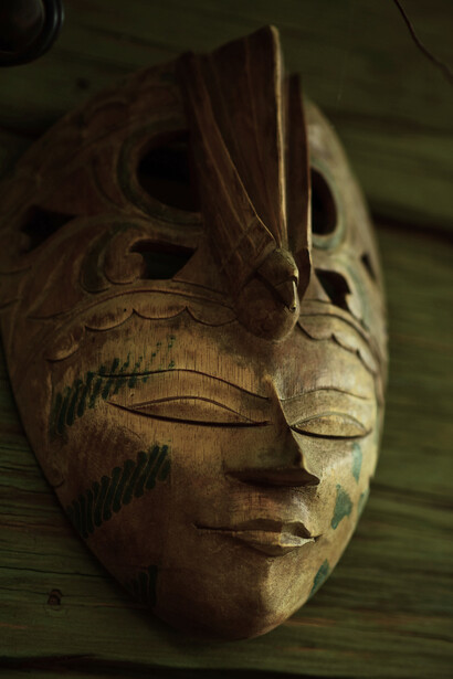 An intricately carved wooden mask preserved with care, symbolising the sacred connection between communities and their ancestors