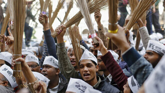 AAP followers waving brooms