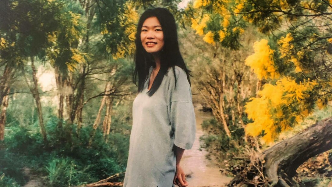 A young Kim Chi Pho in a garden in the middle of autumn