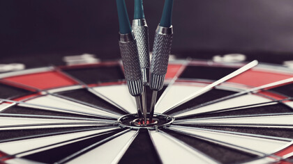 Darts hitting the bullseye, symbolizing success