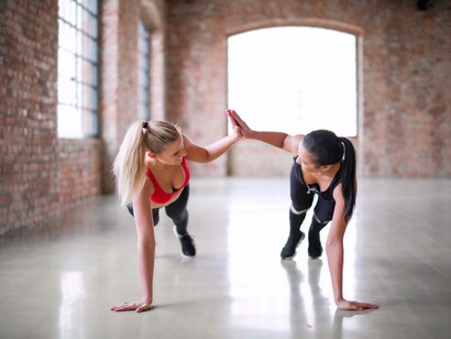 Two women exercising while giving each other a high-five
