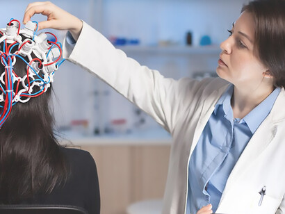 A professional doctor in neuroscience specializing in the development of treatments for neurological diseases is examining a scan