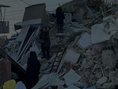People search for their belongings among the rubble, in the aftermath of the deadly earthquake, in Turkey