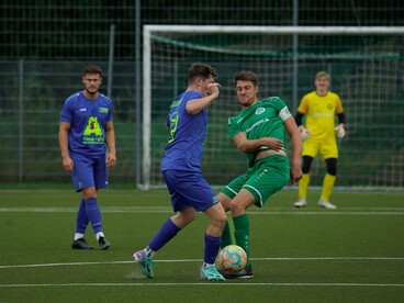 Two players battle for control of the ball, reflecting the fierce competition that energizes fans