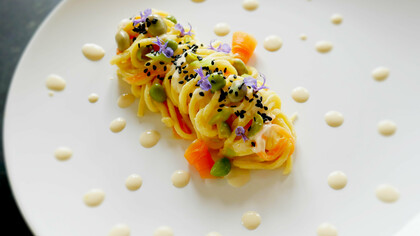 Tagliolini con fave, piselli, sesamo nero e crema di ceci al cumino