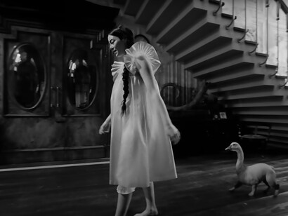 In 'Poor Things,' Emma Stone shares a whimsical moment as she strolls alongside a duck, showcasing her versatility in this enchanting film
