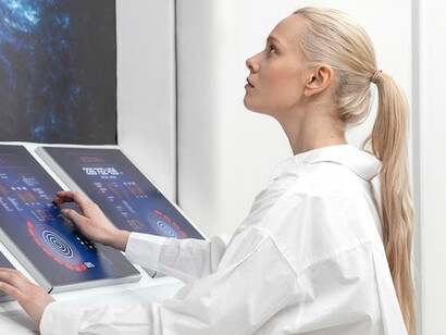 Woman working with digital monitors, showcasing AI technology and automation