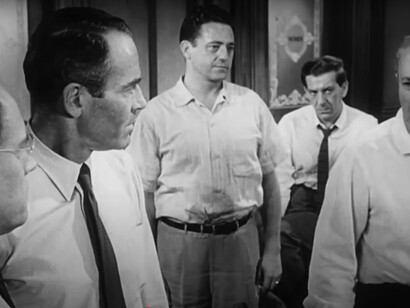 12 Angry Men portrays a tense jury room where personal biases and emotions clash with logic and justice