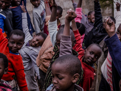 In the midst of their laughter and play, these schoolchildren remind us that joy can thrive even in the shadows of poverty, highlighting the resilience of youth