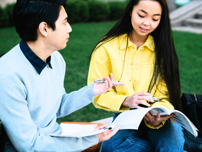 Two students learning side by side on a university campus, conveying the spirit of collaboration and growth fostered by the City College of Ormoc