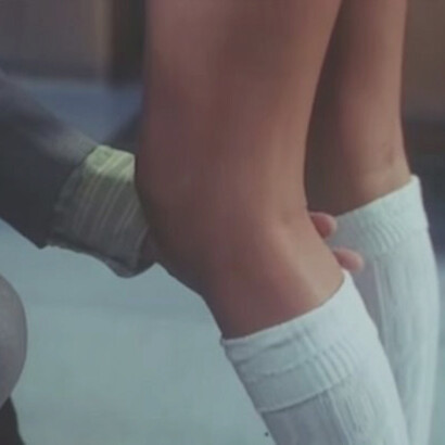 An older man touching his teenage students knee