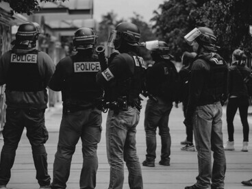 Black and white photo capturing several police officers standing together
