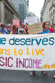 Protesters march for the basic income initiative