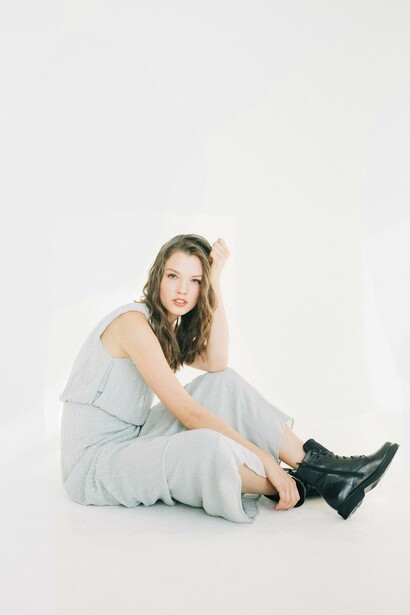 A woman sat alone in a white room. People fear losing money and power