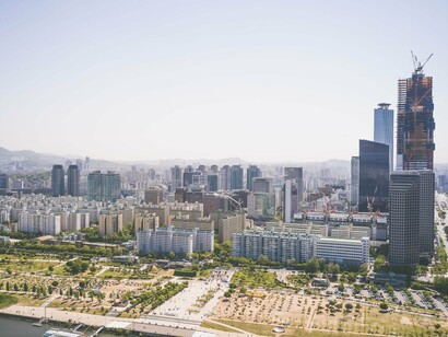 A skyline of Seoul, South Korea, with a skyscraper under construction, representing the nation's commitment to building long-term economic strength