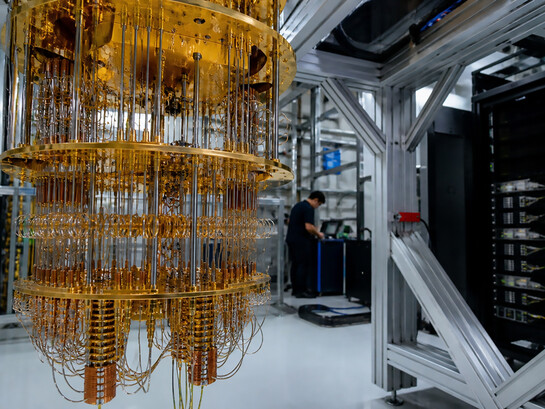 A state-of-the-art quantum computing laboratory featuring a cryogenic quantum processor and advanced computing systems, reflecting the rapid transition of quantum technology from experimental research to real-world industrial applications