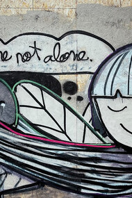 Wall art in Lisbon, Portugal depicting a man hugging a woman—a powerful expression of love and self-expression