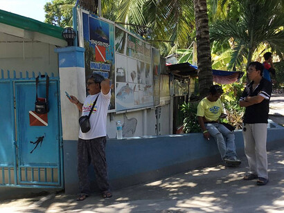 A quiet morning unfolds along the Cebu coastline in the Philippines, where the soft rhythm of waves meets the everyday life of islanders preparing for another day of guiding curious visitors