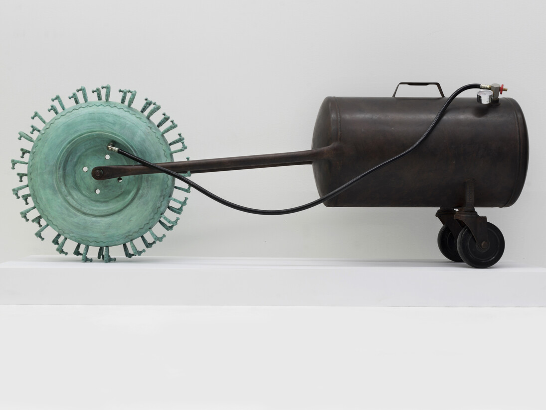 Tao Kulczycki, Wheel-barrow of life (Bhavacakra, cyclic existence), 2014, bronze (wheel-barrow tire, ear aids) green patina, steel (modified air tank), air hose and valve, 20.5 x 56 x 12 in.