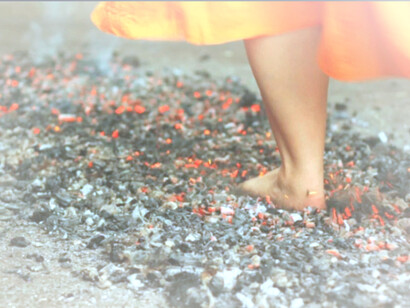 Step out and find out, a woman putting her foot down on the hot coal path