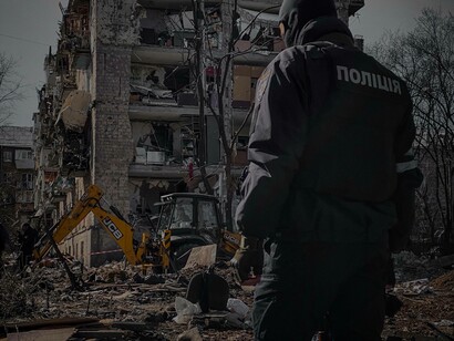 A bulldozer clears the path of the destruction from the war in Ukraine