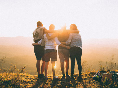 A group of people in an open field enjoying their social bonding; grand moments of discovery are not mere accidents but the results of actively engaging with our environment