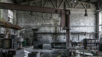 A forgotten factory space with high ceilings and exposed framework, representing the potential for converting industry into habitation