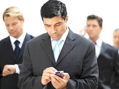Grupo de ejecutivos chateando con sus móviles