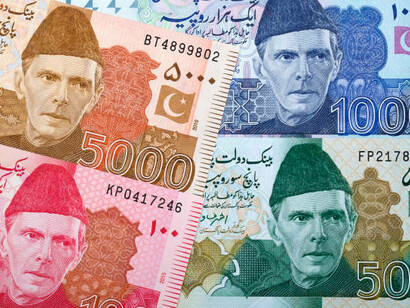 A collection of Pakistani banknotes, featuring the colorful and intricate designs of 50 PKR bills and other denominations
