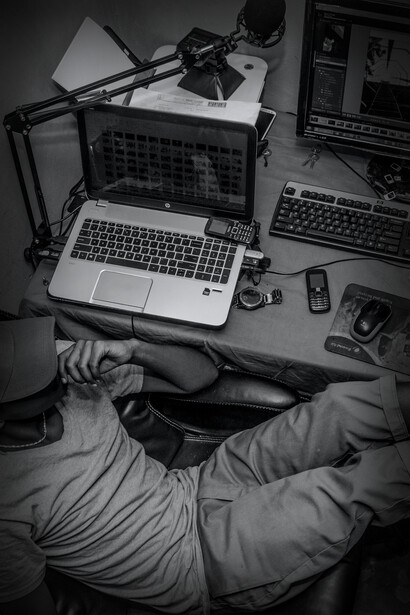A man surrounded by technology lost in thoughts at his job