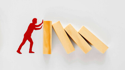 Financial problems, with a downward trending red graph and stack of coins, symbolizing economic challenges and instability