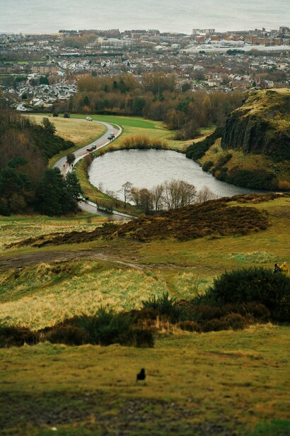 The Holyrood Park in Edinburgh, Scotland, with its grassy volcanic hills and worn footpaths characteristic of Arthur’s Seat