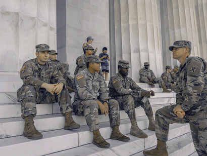 Military soldiers sit watch on the steps of Washington DC, USA