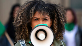 A woman protesting outdoors symbolizes the shift toward grassroots activism