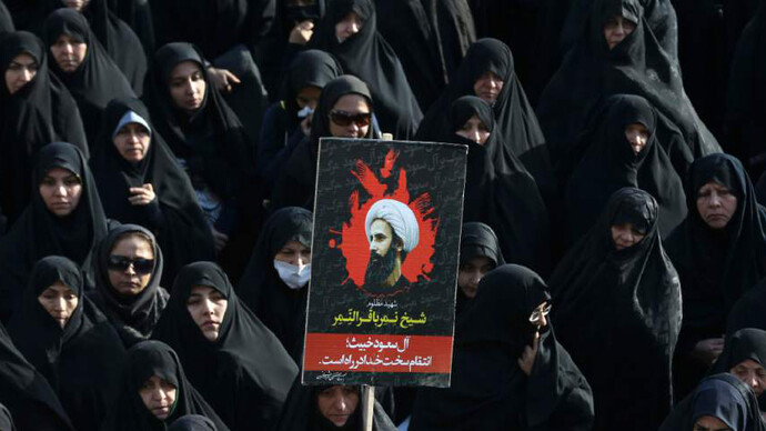 An Iranian woman holds up a poster showing Sheikh Nimr al-Nimr, a prominent opposition Saudi Shiite cleric who was executed last week by Saudi Arabia
