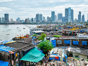 A stark view of Mumbai’s luxury skyline rising behind a slum in the Bandra suburbs