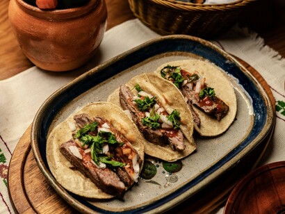 Traditional tacos served on simple plates, representing the authentic flavors that inspire culinary travel