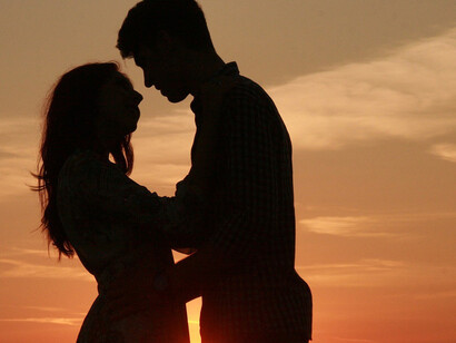 Man and woman hugging during sunset